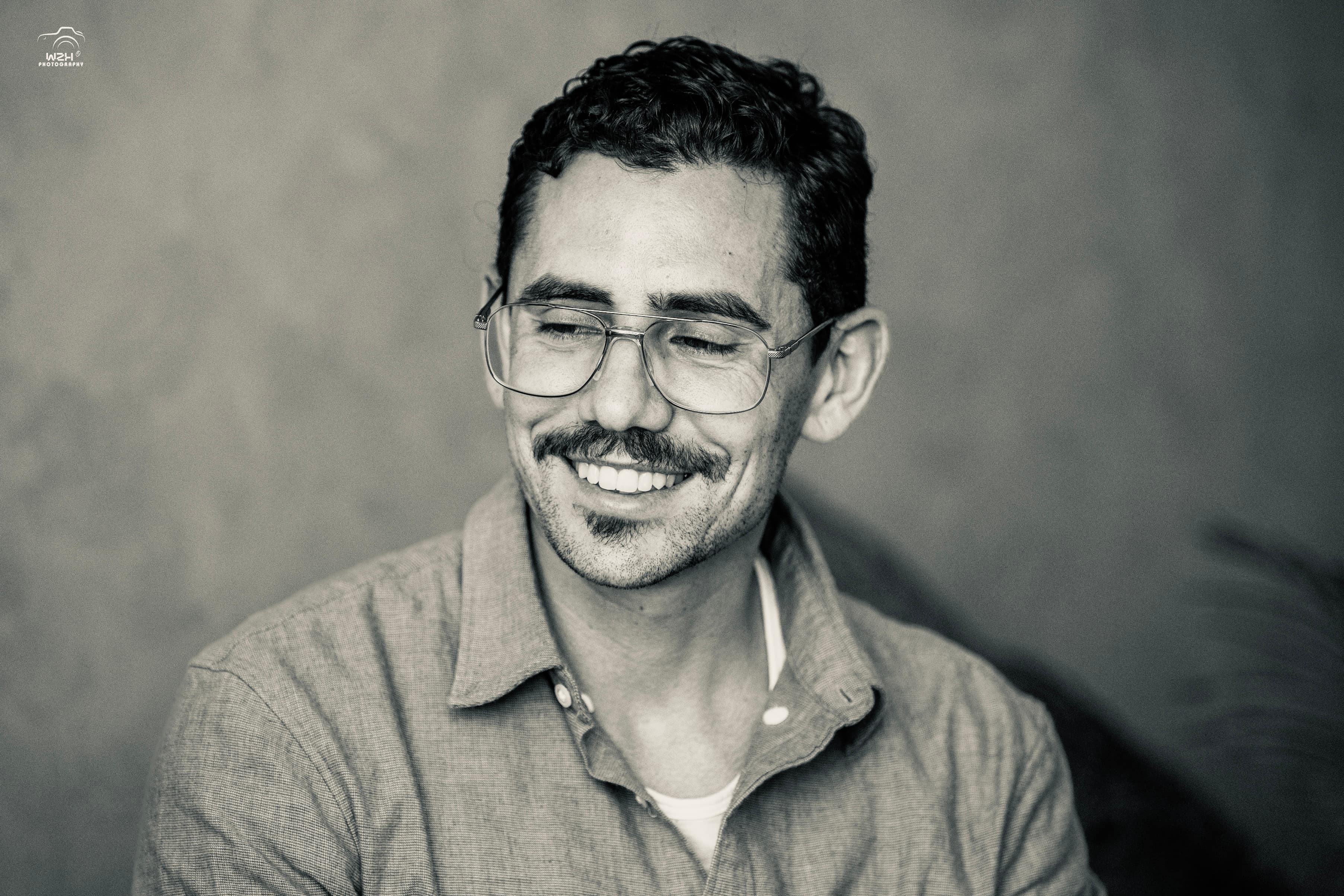 Joshua Beneventi, smiling, mid-conversation